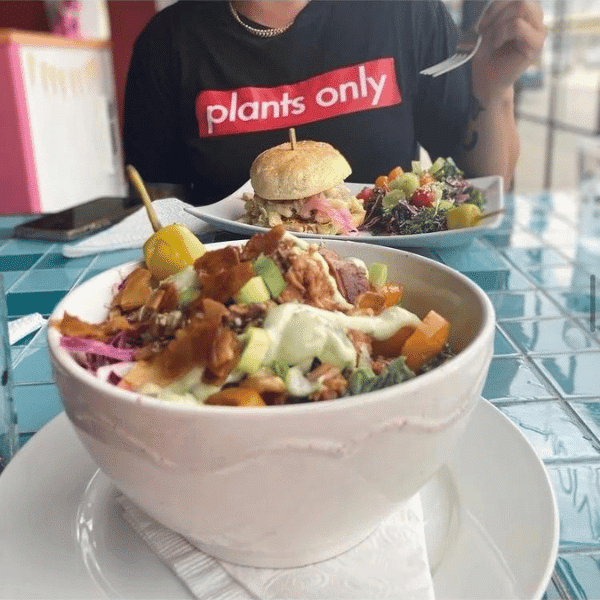 A vibrant and satisfying meal from Chomp Vegan Eatery featuring a hearty bowl of plant-based ingredients and a delicious vegan burger, exemplifying the fresh, flavorful dining experience offered at this popular Vancouver eatery.