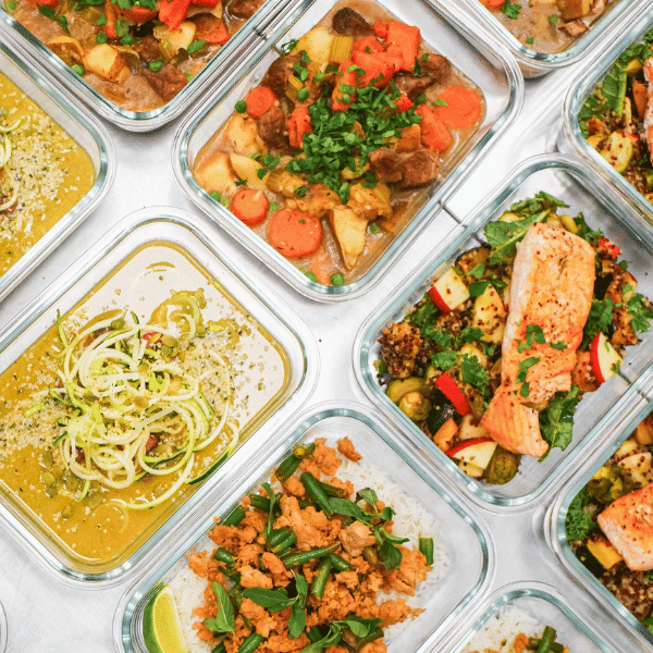 An assortment of nutritious meals prepared by Fresh in Your Fridge, featuring an array of colourful, healthy dishes neatly packed in glass containers, ready to be enjoyed by health-conscious patrons in Vancouver.