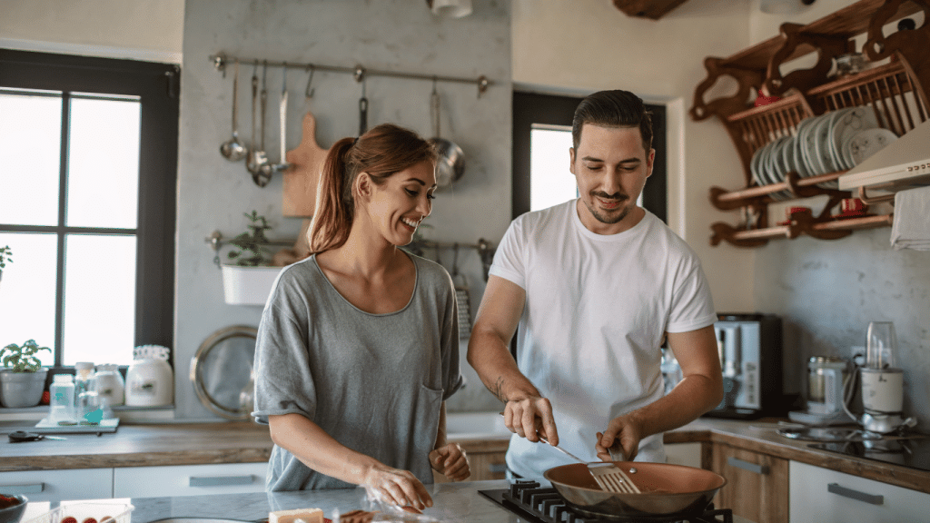 An image of a happy couple cooking a quick meal.