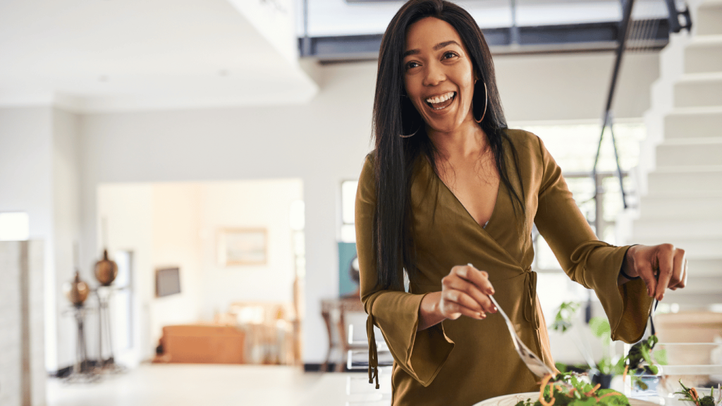 An image of a woman preparing a healthy meal kit salad