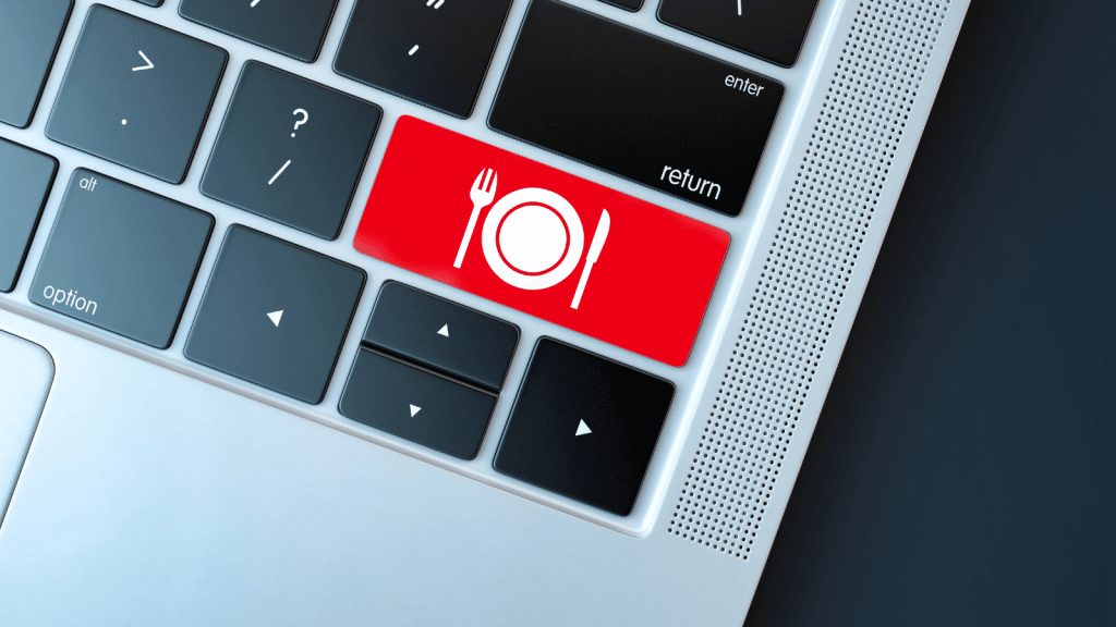 This image depicts a laptop keyboard with a distinctive red button featuring a white plate, fork, and knife icon, symbolizing a meal delivery service. This key stands out among the standard keys, representing the convenience of ordering food with just a click, which is a fitting metaphor for the conclusion section of an article on meal delivery services. It encapsulates the ease and simplicity of using technology to facilitate daily dining needs.